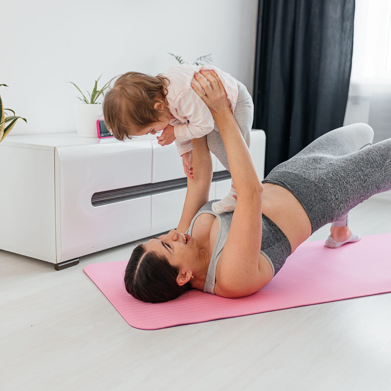 New mom bonding with her baby during her post-natal fitness routine.